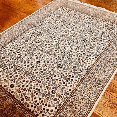Sale Photo Thumbnail #59: Traditional Persian-style area rug featuring an intricate floral and geometric pattern in cream, brown, and tan tones, finished with a fringed border.