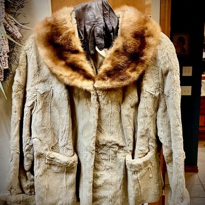 Sale Photo Thumbnail #146: Vintage light brown faux fur jacket featuring a genuine mink fur collar and front pockets, paired with dark brown leather gloves.