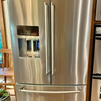 Sale Photo Thumbnail #61: KitchenAid stainless steel French door refrigerator featuring an exterior water and ice dispenser and a bottom freezer drawer.
