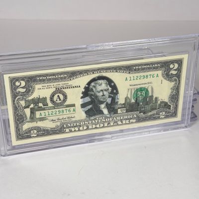 LOT 33: Collection of Ten Vintage $2 Bills with Aftermarket Art Depicting U.S. States in Cases - Ohio, Vermont, Indiana and More