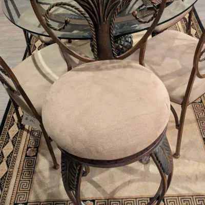 Sale Photo Thumbnail #4: Tuscan-style metal swivel barstool featuring a palm leaf motif backrest and a beige upholstered seat cushion.