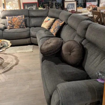 Sale Photo Thumbnail #18: Large contemporary gray fabric sectional sofa featuring reclining end seats, plush backrests, and an assortment of decorative throw pillows.