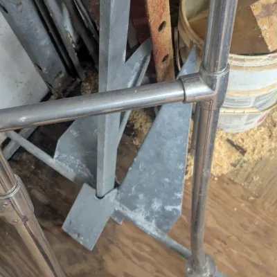 Sale Photo Thumbnail #51: Galvanized steel boat anchor shown alongside stainless steel marine handrails in a workshop setting.