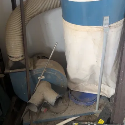 Sale Photo Thumbnail #64: Industrial-style dust collector system with a blue and white collection bag, flexible hose, and blower motor unit, showing signs of workshop use.