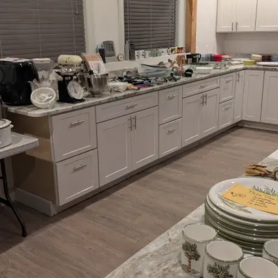 Sale Photo Thumbnail #8: Assorted kitchenware and small appliances, including a stand mixer, air fryer, and palm tree patterned dinnerware set, displayed on kitchen countertops.