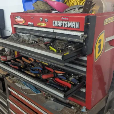Sale Photo Thumbnail #43: Vintage red Craftsman multi-drawer tool chest on a rolling cart, filled with various hand tools, pliers, and wrenches.