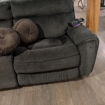 Sale Photo Thumbnail #20: Contemporary charcoal gray fabric reclining sofa section with two round brown decorative accent pillows.