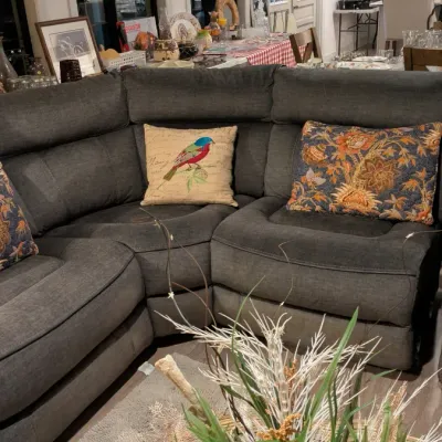 Sale Photo Thumbnail #19: Contemporary dark gray fabric sectional sofa with reclining seats, styled with decorative throw pillows.