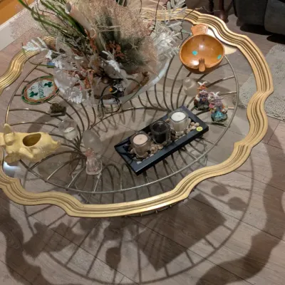 Sale Photo Thumbnail #76: Vintage Hollywood Regency style coffee table featuring a scalloped gold-painted metal frame, a glass top, and a decorative wire base.