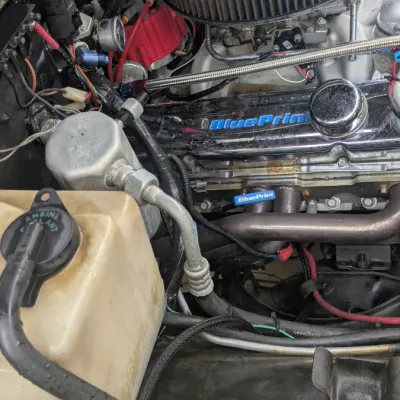 Sale Photo Thumbnail #59: BluePrint Engines crate engine installed in a vehicle bay, featuring a black round air cleaner and chrome valve covers.