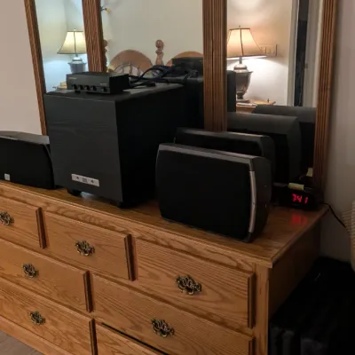 Sale Photo Thumbnail #35: Traditional oak triple-mirror dresser with brass hardware, displaying a modern JBL subwoofer and speaker system.