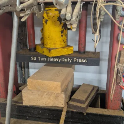 Sale Photo Thumbnail #62: Vintage 30-ton heavy-duty hydraulic shop press with a yellow bottle jack, showing signs of heavy use and wear.