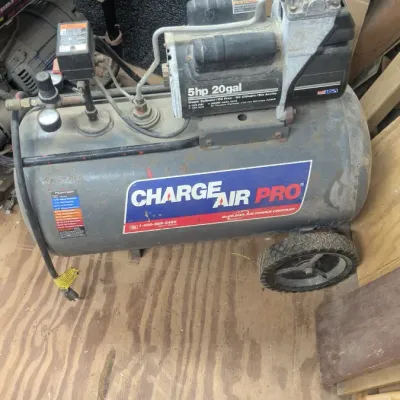 Sale Photo Thumbnail #48: Charge Air Pro 5 horsepower, 20-gallon portable air compressor, showing some surface wear and dust from workshop use.