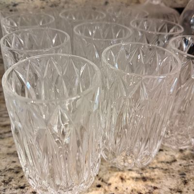 Sale Photo Thumbnail #149: Set of vintage cut crystal tumblers featuring a diamond and vertical line pattern, displayed on a granite countertop.