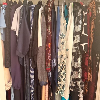 Sale Photo Thumbnail #101: Assortment of women's clothing, including dresses and blouses in various colors, patterns, and textures, hanging in a closet.