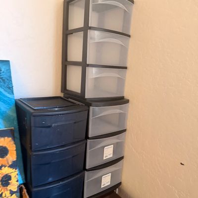 Sale Photo Thumbnail #113: Two Sterilite plastic storage drawer units, including a three-drawer black unit and a six-drawer unit with a black frame and translucent drawers.