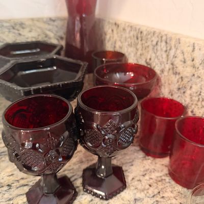 Sale Photo Thumbnail #153: Collection of vintage ruby red glassware, including pressed glass goblets, small tumblers, bowls, and a tall vase.