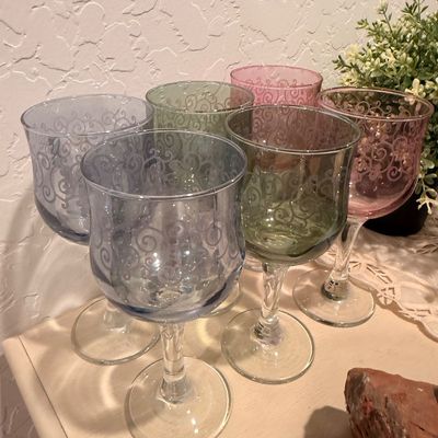 Sale Photo Thumbnail #54: Set of six vintage-style wine goblets in pastel shades of blue, green, and pink, featuring an elegant etched scroll pattern.