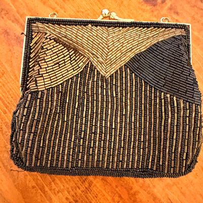 Sale Photo Thumbnail #29: Vintage Art Deco style beaded evening bag featuring a geometric pattern of gold and black bugle beads with a gold-tone kiss-lock clasp.
