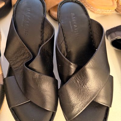 Sale Photo Thumbnail #37: Mazzarelli black leather slide sandals featuring a crisscross strap design and cushioned insoles.