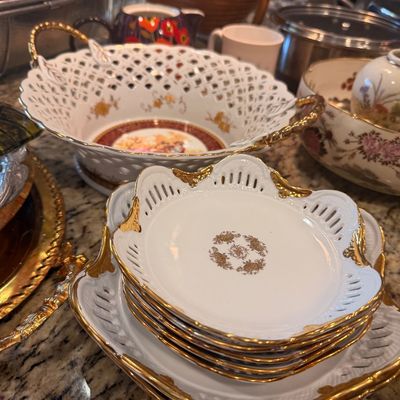 Sale Photo Thumbnail #135: Vintage Schumann Arzberg reticulated porcelain plates and serving bowl with gold trim and floral motifs.