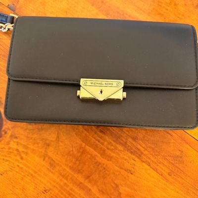Sale Photo Thumbnail #23: Michael Kors black leather clutch purse featuring a gold-tone logo clasp closure and chain strap detail.