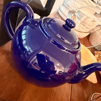Sale Photo Thumbnail #93: Vintage cobalt blue ceramic teapot with lid, featuring a glossy finish and classic round shape.