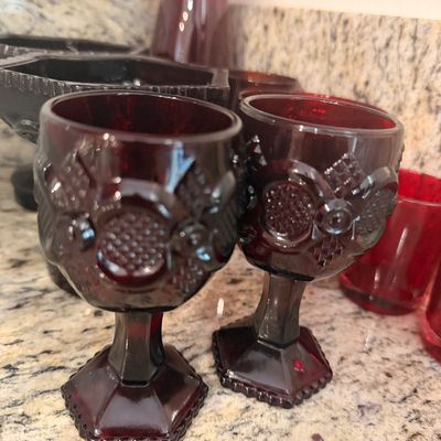 Sale Photo Thumbnail #151: Pair of vintage ruby red pressed glass goblets featuring a textured geometric pattern and hexagonal bases.