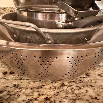 Sale Photo Thumbnail #79: Stack of vintage and modern metal kitchen colanders and strainers, showing some wear from use.