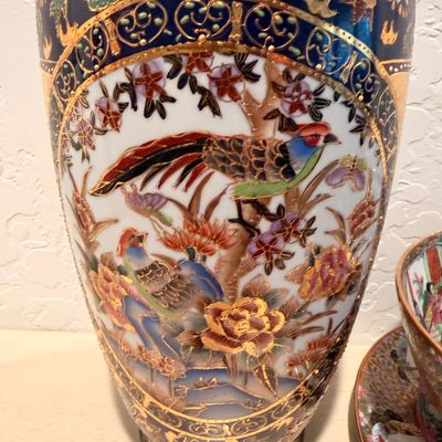 Sale Photo Thumbnail #61: Satsuma-style porcelain vase featuring a hand-painted scene of pheasants among flowers, accented with cobalt blue and gold moriage detailing.