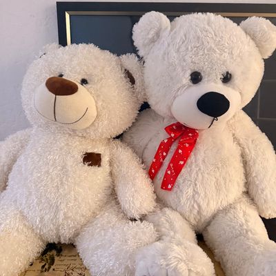 Sale Photo Thumbnail #115: Pair of large, plush white teddy bears, one featuring a red ribbon with white hearts and the other with a brown nose and paw pad details.