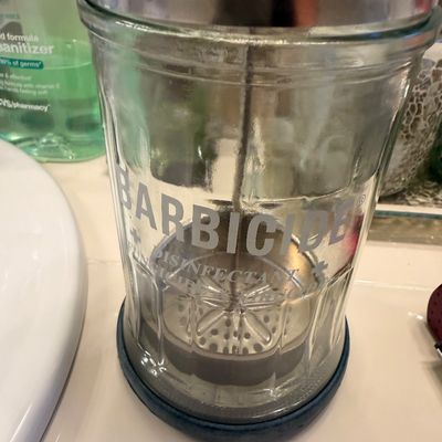 Sale Photo Thumbnail #107: Vintage Barbicide disinfecting jar with glass body, metal lid, and inner basket, showing some light wear.