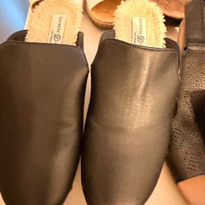 Sale Photo Thumbnail #39: Chinese Laundry black leather mule slippers featuring a cozy faux-shearling lining, shown alongside other women's shoes.