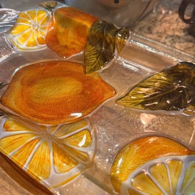 Sale Photo Thumbnail #134: Textured glass serving platter featuring a vibrant citrus design with raised orange slices, whole oranges, and green leaves.