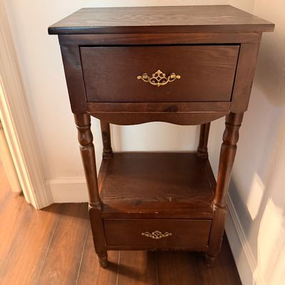 Sale Photo Thumbnail #49: Traditional dark wood nightstand featuring a top drawer, an open middle shelf, and a bottom drawer, accented with ornate brass pulls and turned legs.