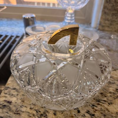 Sale Photo Thumbnail #143: Vintage cut crystal covered candy dish featuring a geometric pattern and a gold-toned metal handle on the lid.