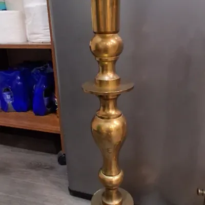 Vintage tall brass candlestick holder featuring a baluster-style turned stem and a wide circular base.
