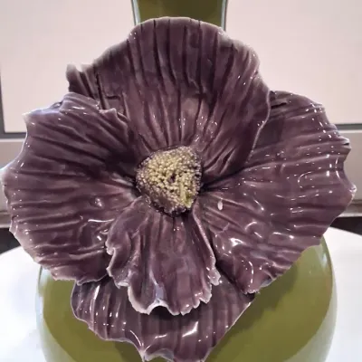 Ceramic olive green vase featuring a large, detailed purple flower applique with a textured center.