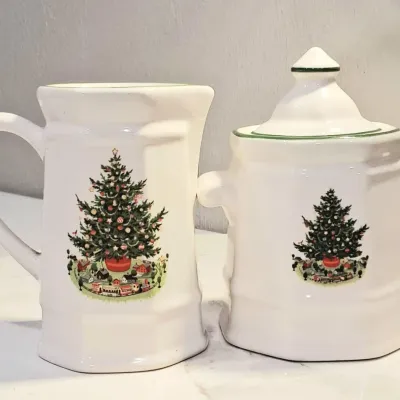 Spode Christmas Tree pattern ceramic creamer and lidded sugar bowl set, featuring the classic decorated holiday tree design on a white...