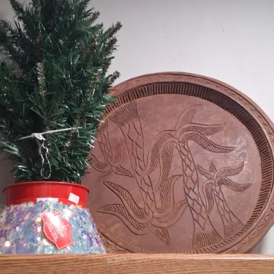 Vintage hand-carved wooden serving tray featuring a tropical palm tree motif, shown alongside a small artificial Christmas tree in a red...