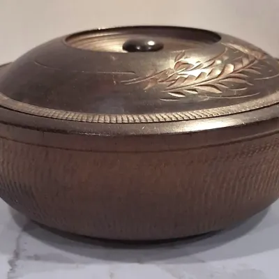 Vintage hand-carved wooden bowl with a matching lid, featuring a textured exterior and an engraved leaf motif on the top.