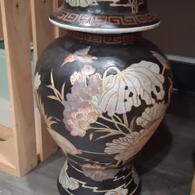 Vintage Chinoiserie black ceramic ginger jar with lid, featuring a hand-painted design of lotus flowers, lily pads, and birds with Greek...