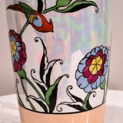Vintage Japanese lusterware porcelain vase featuring a hand-painted floral and bird motif with a peach-toned base and rim, circa 1930s.