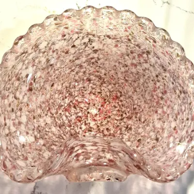 Vintage Murano-style art glass bowl featuring a ruffled, crimped rim and a pink and white spatter or end-of-day glass pattern with...