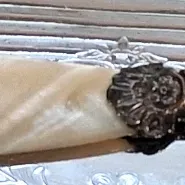 Antique Victorian sterling silver butter knife featuring an ornate, detailed handle and a carved mother-of-pearl blade with a scalloped...