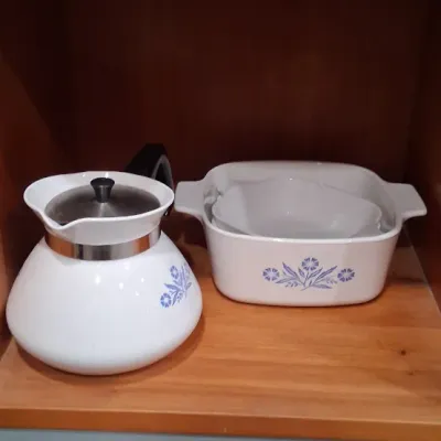 Vintage Corning Ware Blue Cornflower pieces, including a P-104 teapot with lid and a square casserole dish with nested bowl, displayed on...