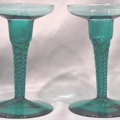 Pair of vintage teal green glass candlesticks featuring a spiral-twisted stem design and wide circular bases.