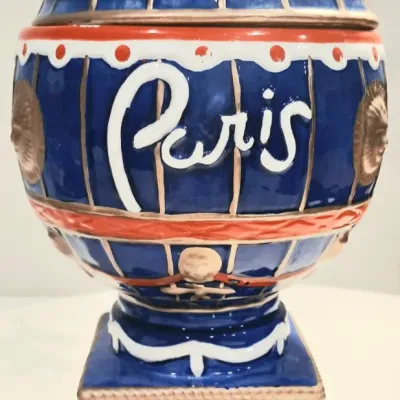 Paris Las Vegas souvenir ceramic hot air balloon cookie jar, featuring a blue, red, and white glazed design with gold accents and a...