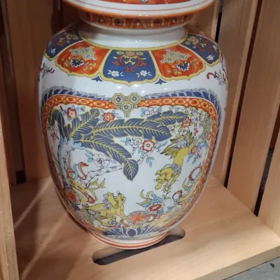 Vintage Chinese Imari-style porcelain ginger jar with lid, featuring intricate hand-painted floral, foliage, and animal motifs in vibrant...