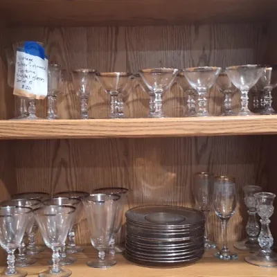 Collection of vintage silver-rimmed Fostoria crystal glassware, including a set of five stemmed glasses, matching plates, and assorted...
